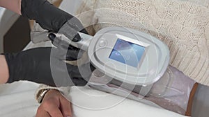 Woman getting cryolipolysis fat treatment procedure in professional cosmetic cabinet, closeup