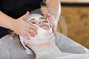 Woman getting enzymatic peeling at beautician`s photo