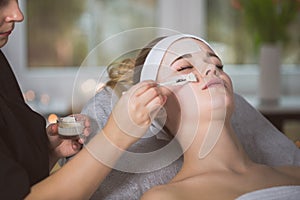 Woman getting an enzymatic peeling treatment photo