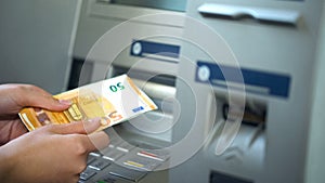 Woman getting euros from automatic teller machine, cash withdrawing, banking