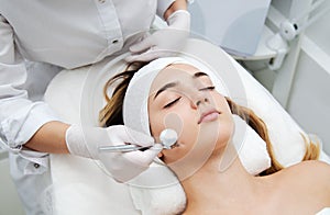 Woman getting face beauty treatment in medical spa center