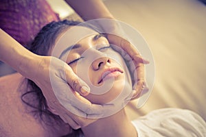 Woman getting face and head massage in Thai Massage spa