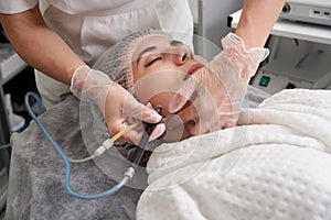 Woman Getting Facial Hydro Microdermabrasion Peeling Treatment At Cosmetic Beauty Spa Clinic. Hydra Vacuum Cleaner