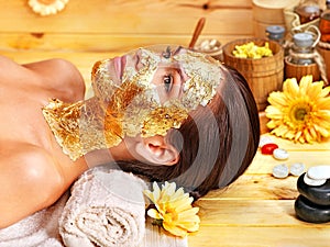 Woman getting facial mask .