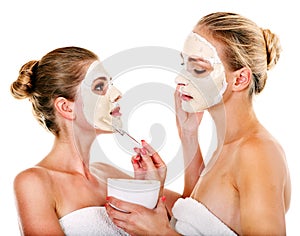 Woman getting facial mask.