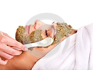 Woman getting facial mask in spa .