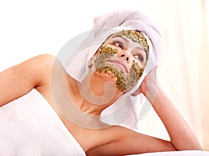 Woman getting facial mask in spa .