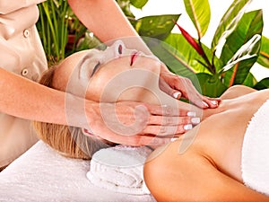 Woman getting facial massage .