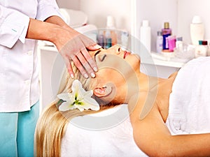 Woman getting facial massage .