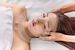 Woman getting facial spa massage treatment at beauty spa salon