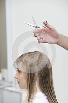 Woman Getting Haircut At Parlor