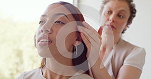 Woman getting a head massage in a spa. Massage therapist gently rubbing a young relaxing female in a wellness center