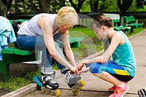 Woman getting help putting on rollerblades