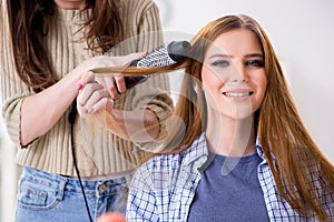 The woman getting her hair done in the beauty salon