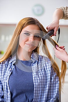 The woman getting her hair done in the beauty salon