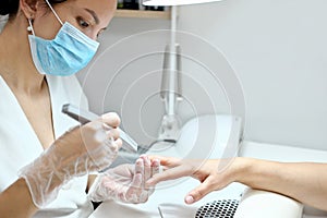 woman getting her nails done by a manicurist