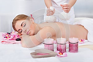 Woman Getting Herbal Compress Ball Therapy photo