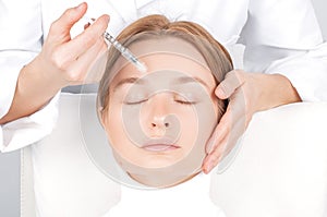 Woman is getting injection. Anti-aging treatment and face lift. Facial skin lifting injection to woman`s face