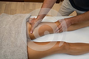 Woman getting legs massage in spa salon