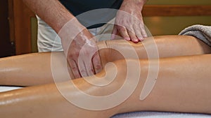 Woman getting legs massage in spa salon