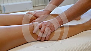 Woman getting legs massage in spa salon