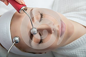 Woman getting lifting therapy massage in a beauty SPA salon photo