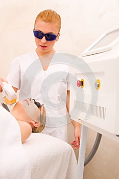 Woman getting light pulsed hair removal treatment