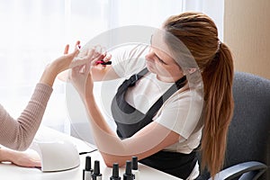 Woman getting a manicure at the nail salon