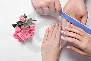 Woman getting nail manicure in salon.