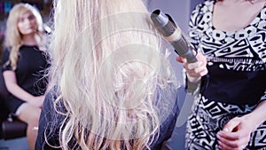 Woman getting new haircut by hairdresser at parlor