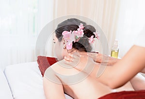 Woman getting Oil Massage on her back in Thai Spa