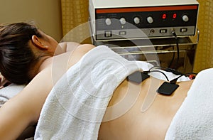 Woman getting physical therapy with eletrical stim