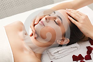 Woman getting professional facial massage at spa