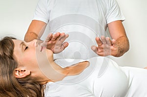 Woman getting reiki healing therapy - alternative medicine