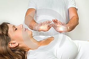 Woman getting reiki healing therapy - alternative medicine