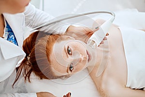 Woman getting rf-lifting in a beauty salon. Modern technologies in cosmetology.