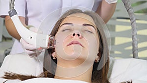 Woman getting rf-lifting in a beauty salon. Woman having a stimulating facial treatment. Skin care face. Skin treatment