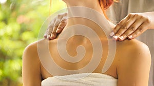 Woman getting shoulder massage at spa