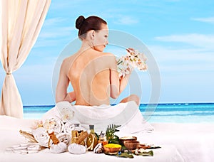 Woman getting spa lastone therapy outdoor.