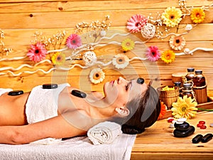 Woman getting stone therapy massage