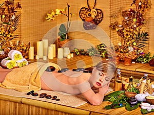 Woman getting stone therapy massage