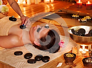 Woman getting stone therapy massage