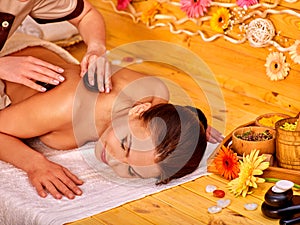 Woman getting stone therapy massage