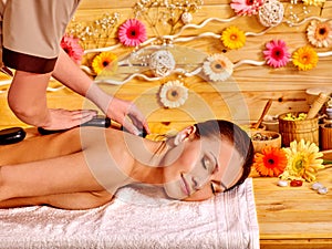 Woman getting stone therapy massage