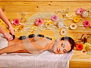 Woman getting stone therapy massage