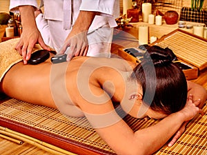 Woman getting stone therapy massage