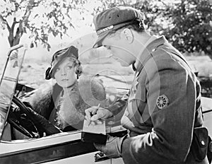 Woman getting a ticket from a policeman