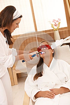 Woman getting tooth whitening