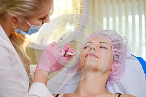 Woman getting treatment with injectable hyaluronic acid dermal filler