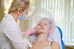 Woman getting treatment with injectable hyaluronic acid dermal filler